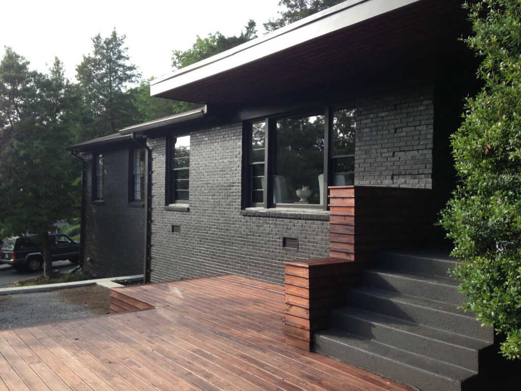Black House with Wooden Accents