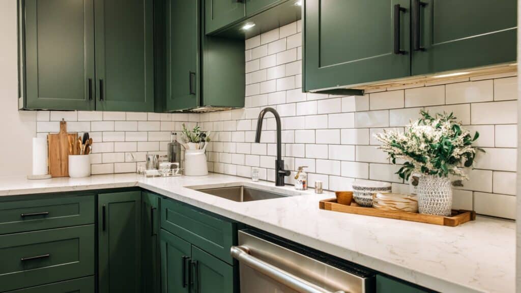 dark green kitchen with white subway tile backsplash